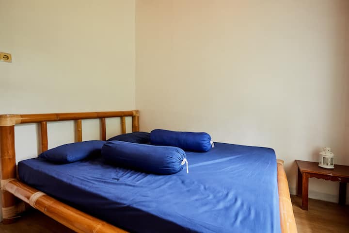 This is the front bedroom that can accommodate 2 people, with bedside table. 