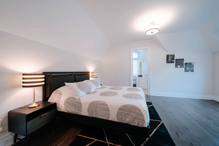The fourth bedroom attributes gold and black accents to create a royal and outstanding theme