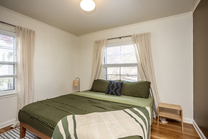 Bright and comfortable, this main-floor bedroom features a plush king bed, nightstands, and a full closet for storage. With soft linens and room-darkening shades, it’s the perfect place to unwind and enjoy a restful night’s sleep.