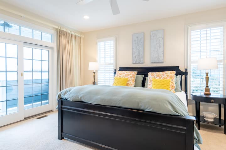 King bed, ceiling fan, private deck, private bathroom, closet, room darkening curtains.  TV.  Main floor.