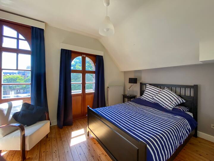 The blue bedroom with double bed & open view of the square.
