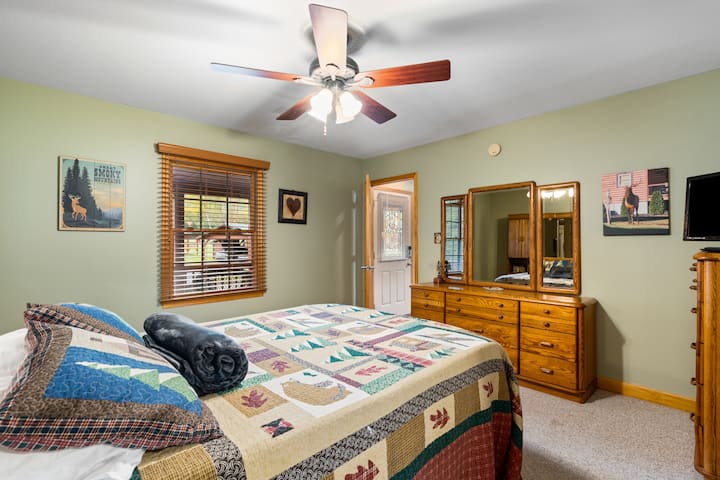 Downstairs master bedroom featuring a queen bed with 3 inch Tempur-Pedic topper, TV, en-suite bathroom and walk in closet. 