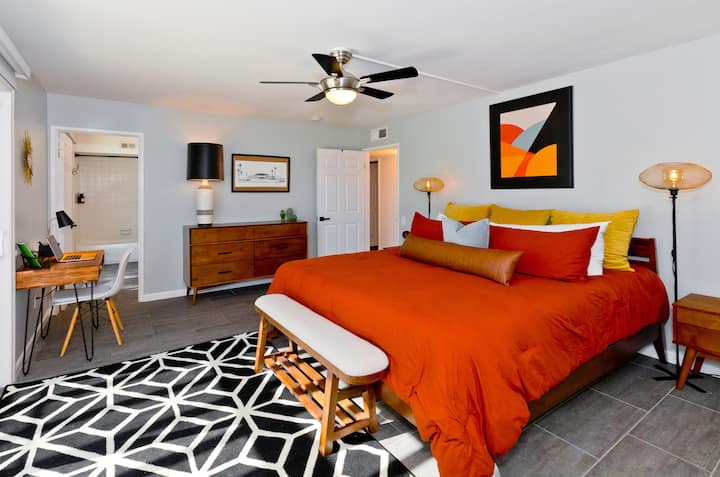 Master bathroom, king memory foam mattress, Smart TV, desk, dresser, large mirrored closet, benches, 2 glass sliders in bedroom and en suite bathroom, ceiling fan, bedside charging ports and blackout roller shades.