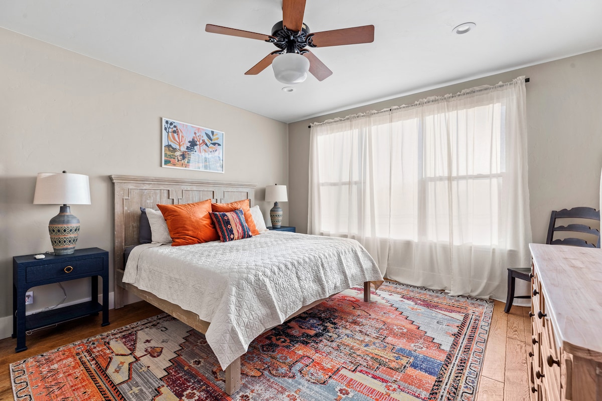 Chumba kikuu cha kulala kina kitanda cha kifalme, runinga na bafu kamili, beseni la kuogea la miguu, bafu la kuingia