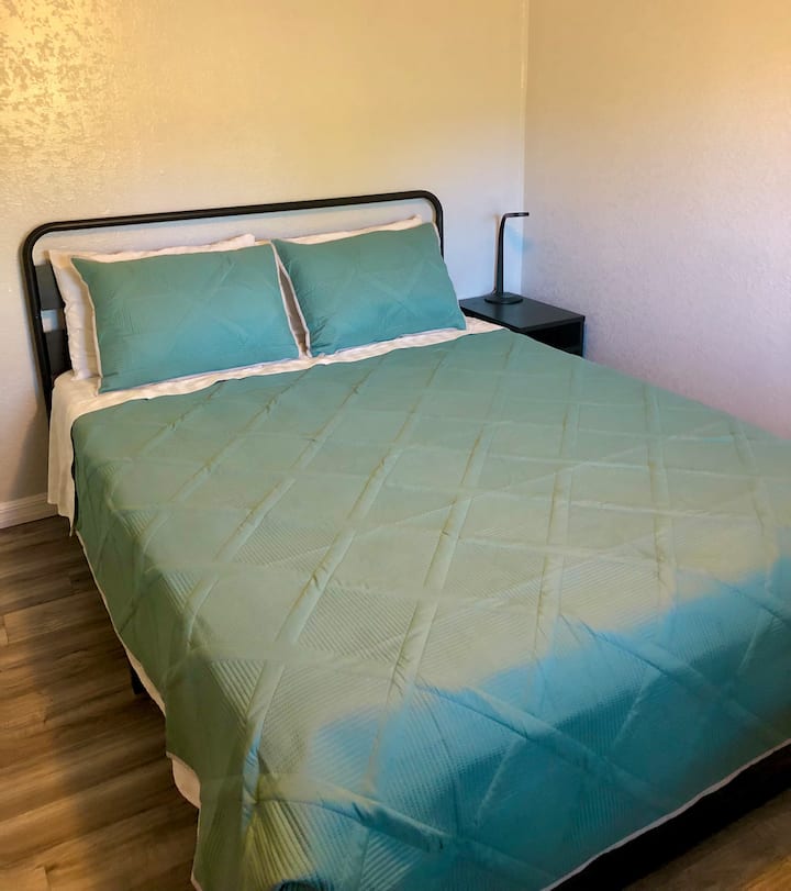 Queen sized bed, bedroom with dedicated workspace