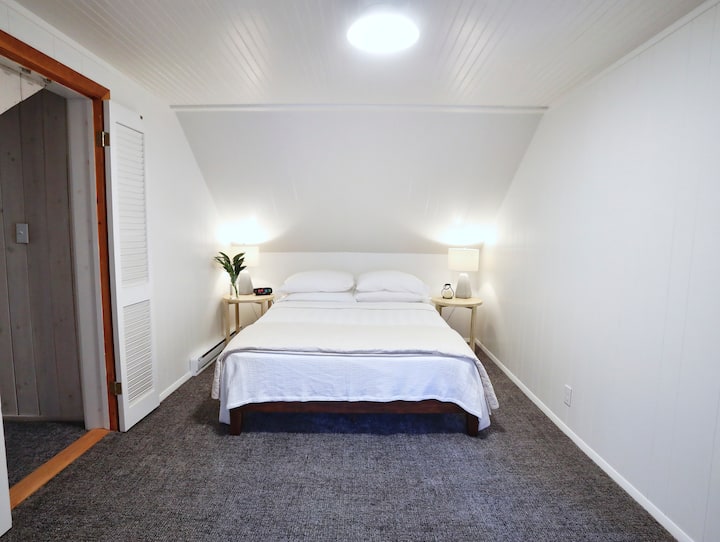 The upstairs queen bed is adjacent to an open bonus room and shares a bathroom with the twin room.
