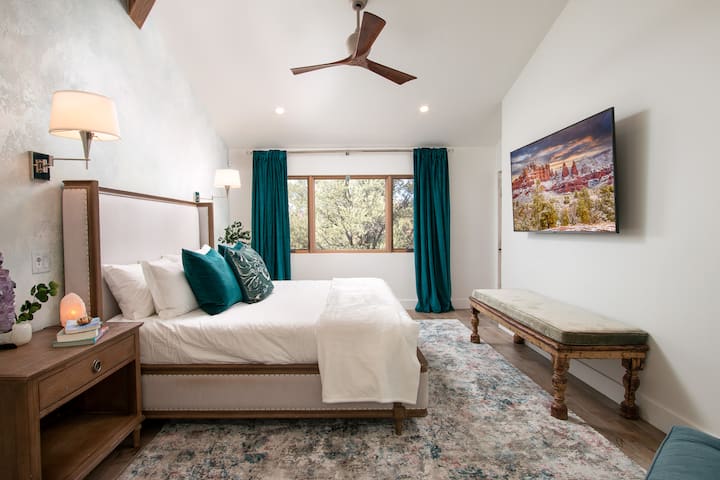 Inviting, light-filled primary suite with a luxurious king-sized bed and hotel-grade linens