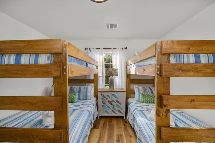 Third bedroom with two bunk beds — one full-over-full and one twin-over-twin — perfect for kids or groups.