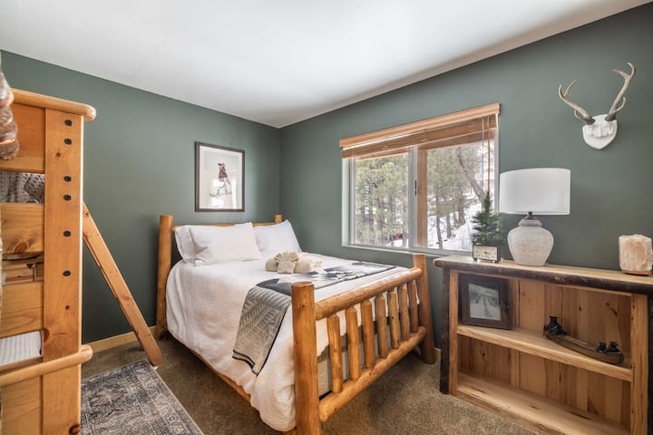 Bedroom #3 is located on the lower level. It has 1 bunk bed (2 twin beds), 1 full bed, a dresser, and a ceiling fan.