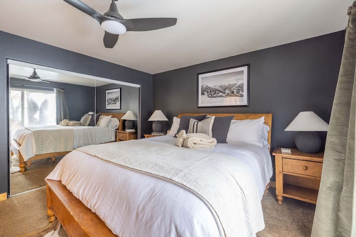 Bedroom #1 is the master bedroom located on the lower level and has private patio access to a hot tub for 8 guests. This bedroom has 1 California king bed, Sony TV, closet, dresser, ceiling fan, carpet floor, and an attached ensuite master bathroom.