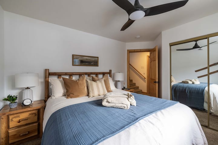 Bedroom #2 is located on the lower level. It has 1 California king bed, ceiling fan, carpet floor, closet, and dresser.