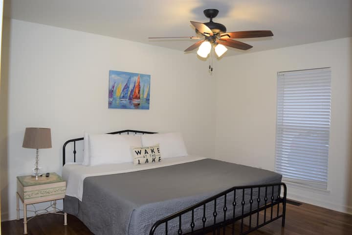 Located on the main floor, this bedroom sports a king bed, closet, and its own TV. The bathroom is located just outside the door in the hallway. 