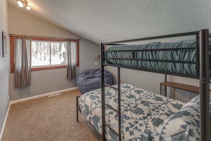 Lower bedroom with twin over full bunk beds & beanbag chair.