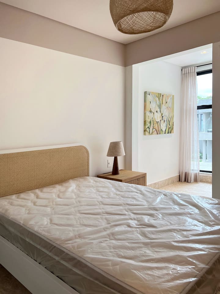 Dormitorio con balcón integrado y cortina opaca 