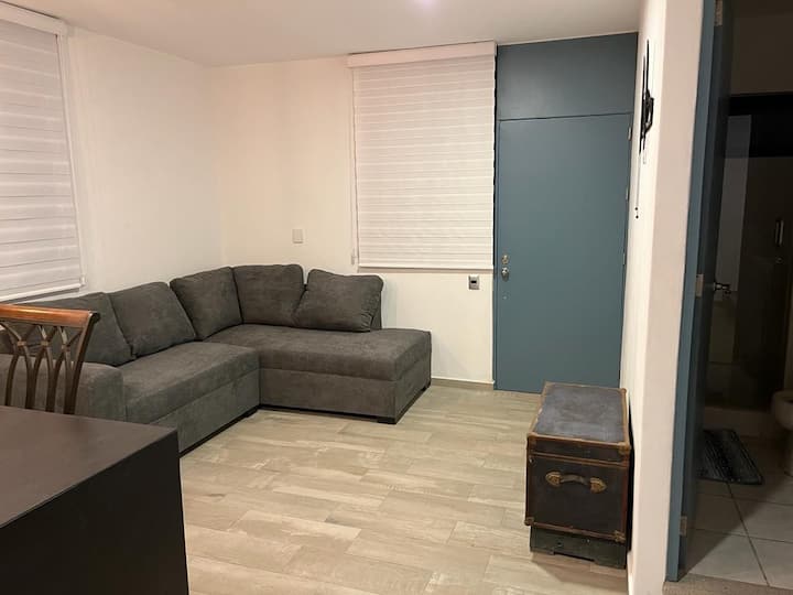 Uitzicht op de comfortabele bank in de woonkamer. Hier kun je rusten terwijl je naar de smart-tv kijkt 