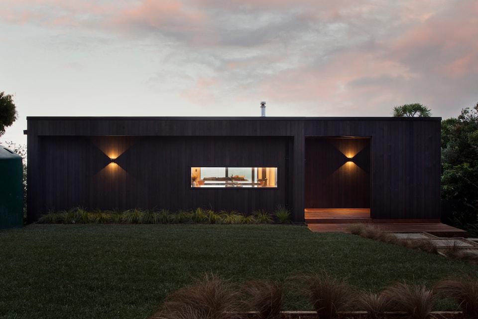 A black-timber house above Piha Beach, Piha, Auckland, New Zealand, photo 4 of 10