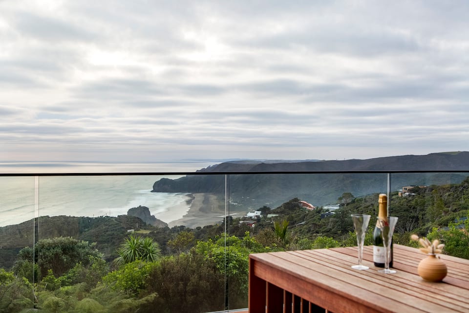 A black-timber house above Piha Beach, Piha, Auckland, New Zealand, photo 1 of 10