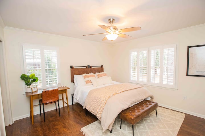 Bedroom 2 features a comfortable Queen size bed, quality pillows and linens, 55" Roku TV, plantation shutters, remote ceiling fan, desk, closet, and attached Jack & Jill Bath shared with Bedroom 3.