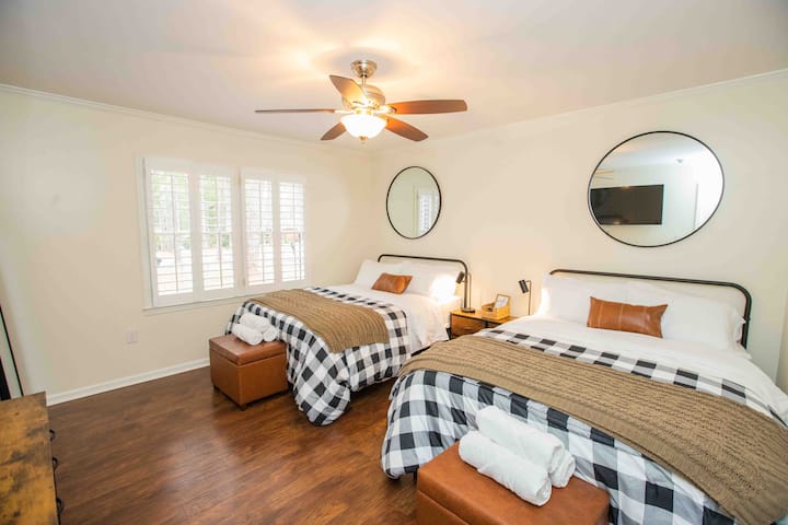Bedroom 3 features 2  comfortable full size beds, quality pillows and linens, 55" Roku TV, plantation shutters, remote ceiling fan, desk, walk in closet, full length mirror, and attached Jack & Jill Bath shared with Bedroom 2.