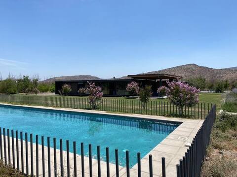 House on a plot with a pool