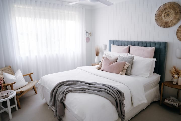Guest Bedroom 2, features a queen bed with plush pocket spring mattress and fabric bedhead