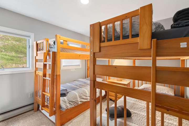 第三间卧室配有舒适的双层床，是儿童或额外房客的理想场所。 客房配有阅读灯、充电端口和充足的衣柜空间