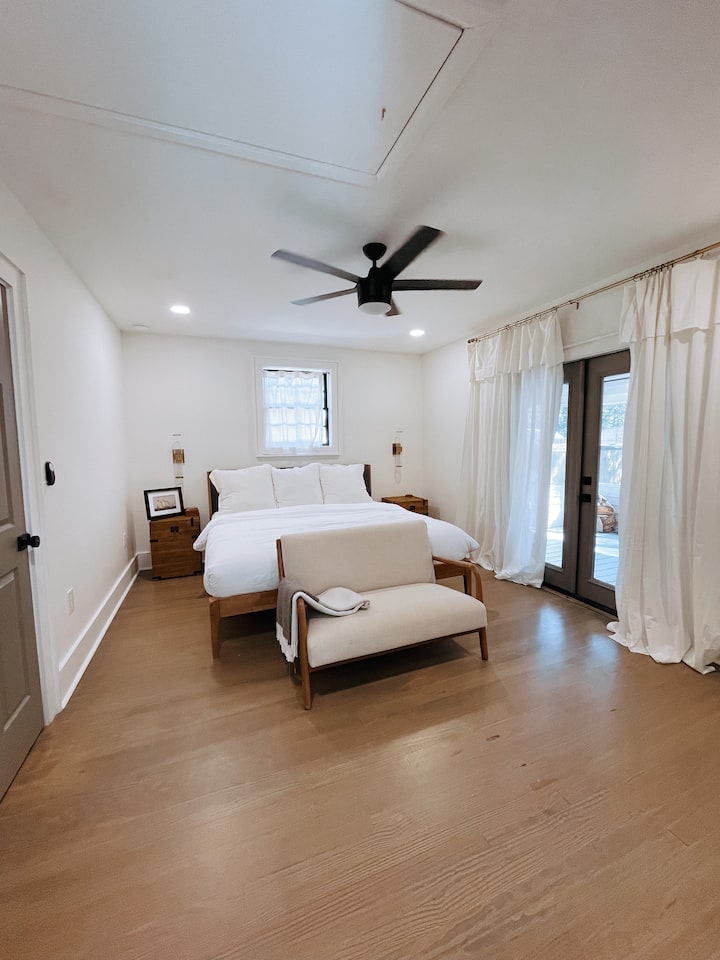 Cama king e quarto que leva ao deck dos fundos.