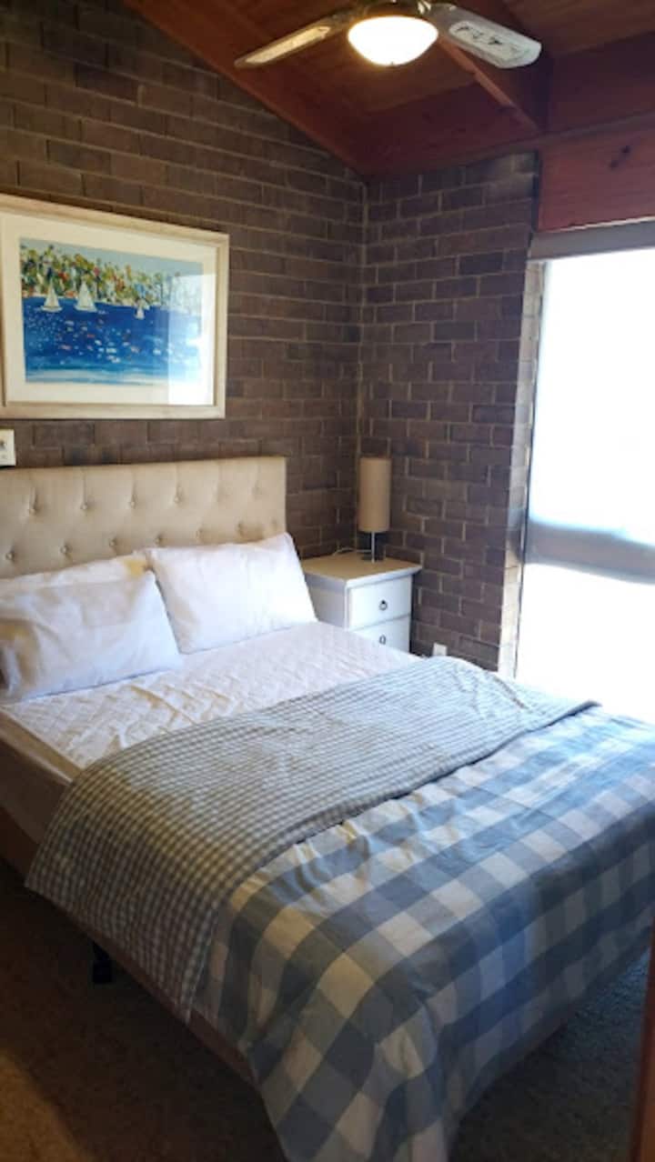 غرفة نوم 2 بسرير بحجم كبير ومروحة سقف وإطلالات على بير والبحر.