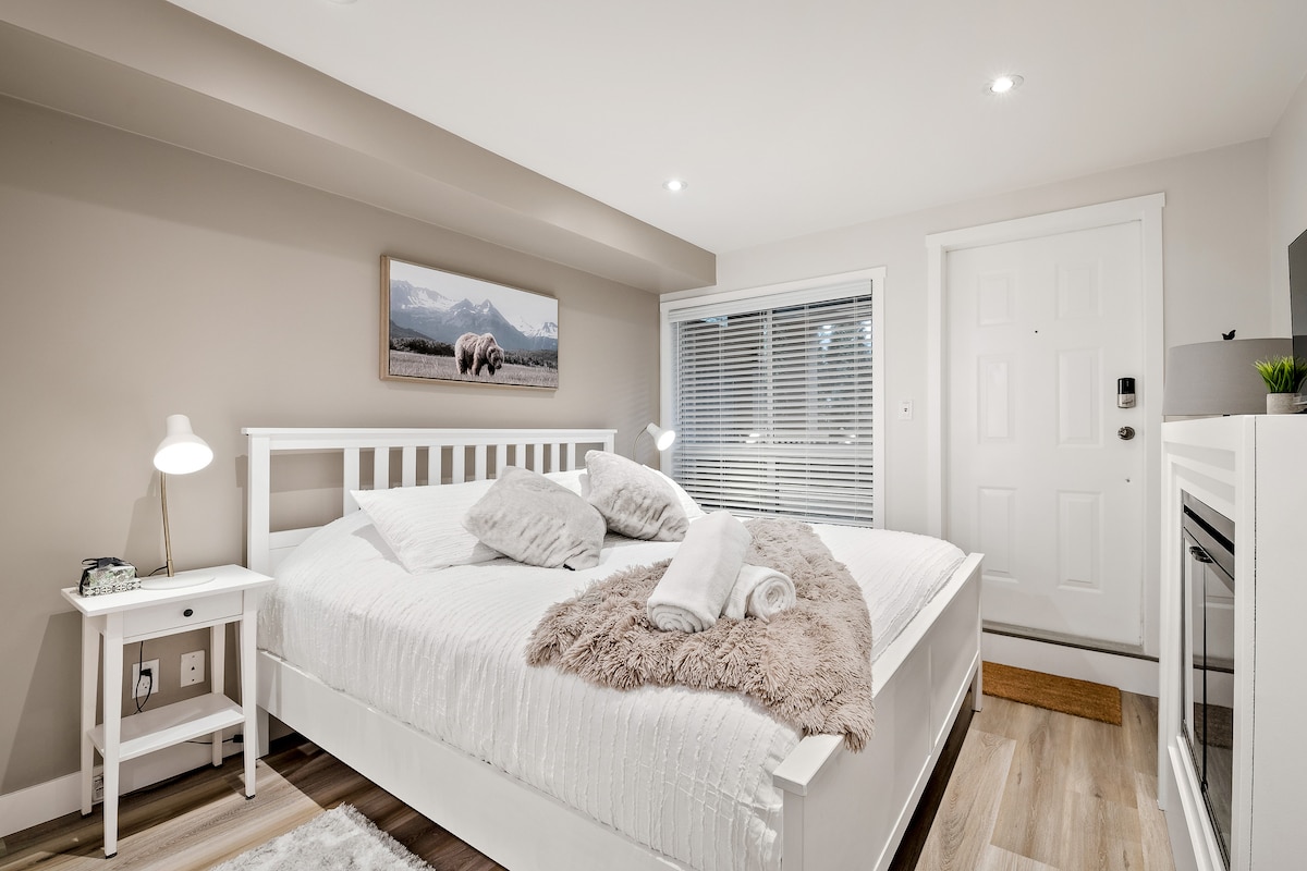Main Bedroom with a King bed, fireplace, TV and exit door to hot tub.