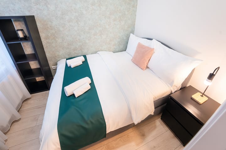 A stylish sleeping space with cozy details and a calm, minimalist design.