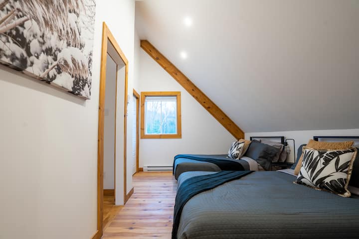 Bedroom featuring two comfortable double size bed and an ensuite half bath.  A touch of luxury.