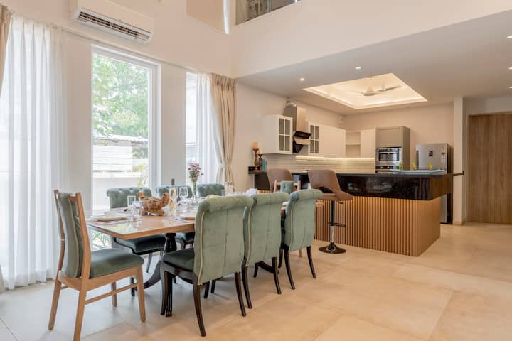 Modern dining meets sleek kitchen design for an inviting culinary experience.