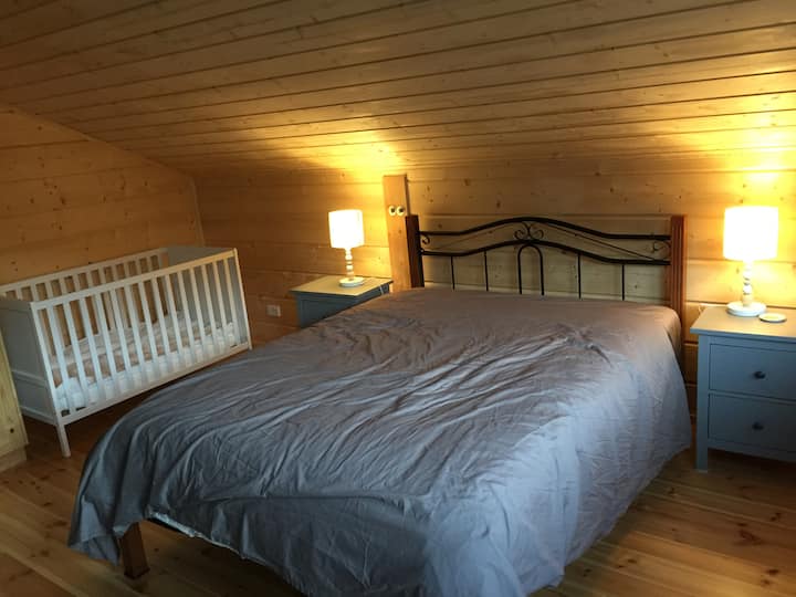 Queen-sized bed room with cot