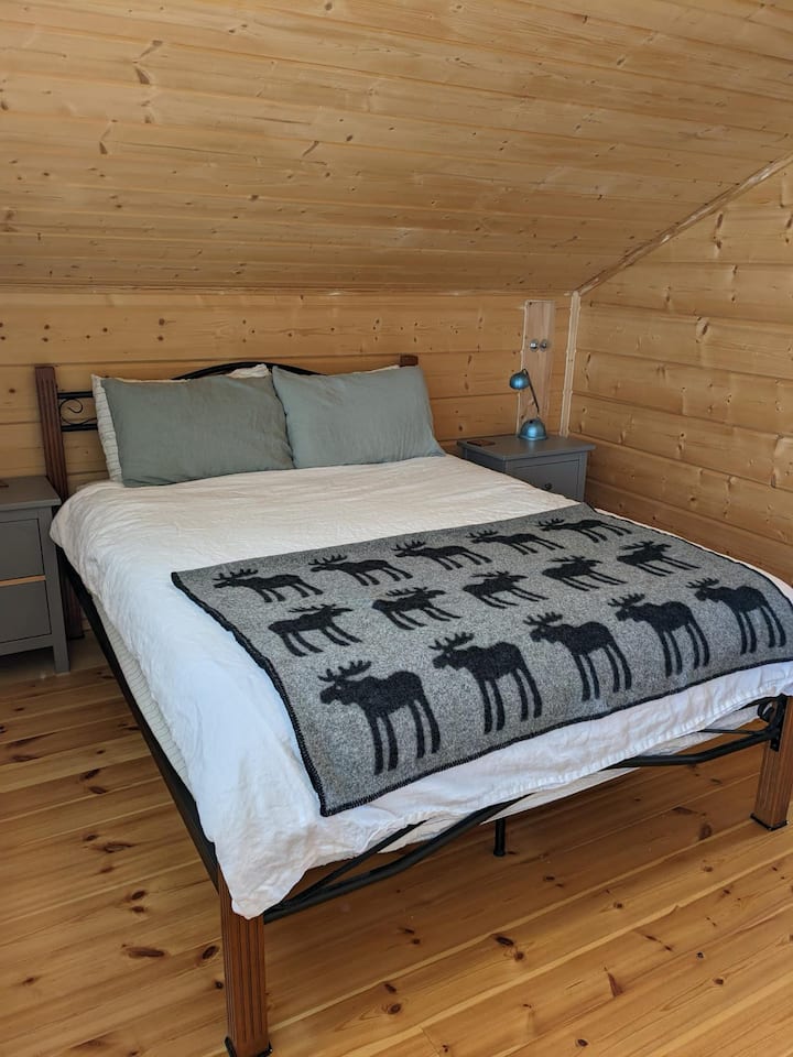 One of 4 queen-sized bed rooms each with wardrobes, bedside tables and lamps