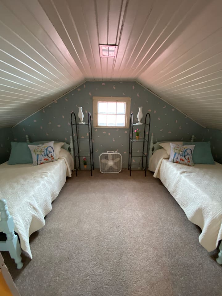 Upstairs bedroom with twin single beds.