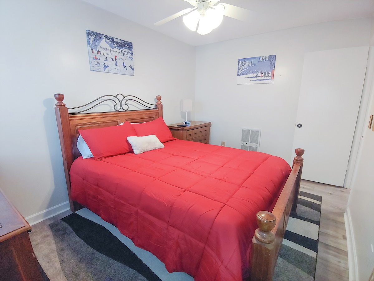Bedroom: Bright and inviting retreat with a queen bed, rich wooden accents, and charming decor!