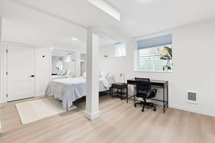 Светла и спокойна спалня с плюшено двойно легло, меки чаршафи и модерно обзавеждане. Работното място е разположено до прозореца, създавайки спокойно и функционално място за почивка или работа.