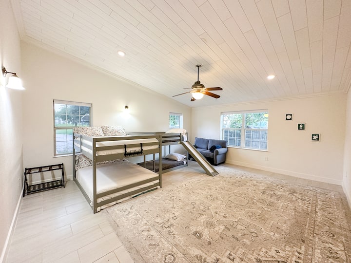 A bunk bedroom has two full beds and two twin beds( Full on full and twin on twin).
there is a loveseat sofa in this room as well
A big room with a lot of space perfect place for the kids to play.