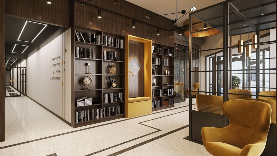 A modern corridor showcases sleek wooden shelving filled with books and decorative items. Comfortable seating areas feature vibrant yellow armchairs. Soft lighting enhances the contemporary design, while large glass partitions separate different spaces, contributing to an open and inviting atmosphere.