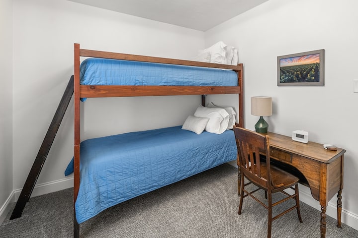 Twin bedroom— bunk beds, desk, Roku TV, luggage rack