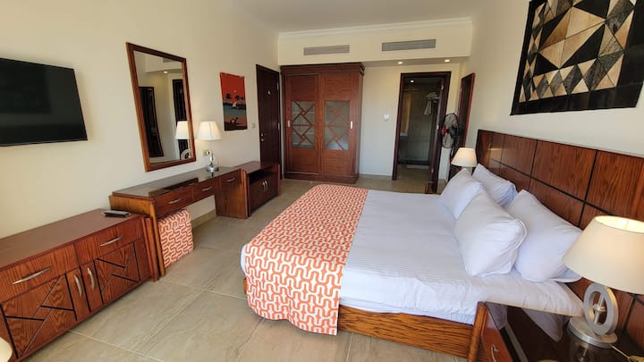 Master Bedroom, King Size Bed, 42" TV w/ Cable, en-suite full bathroom, private balcony overlooking pool and ocean view.