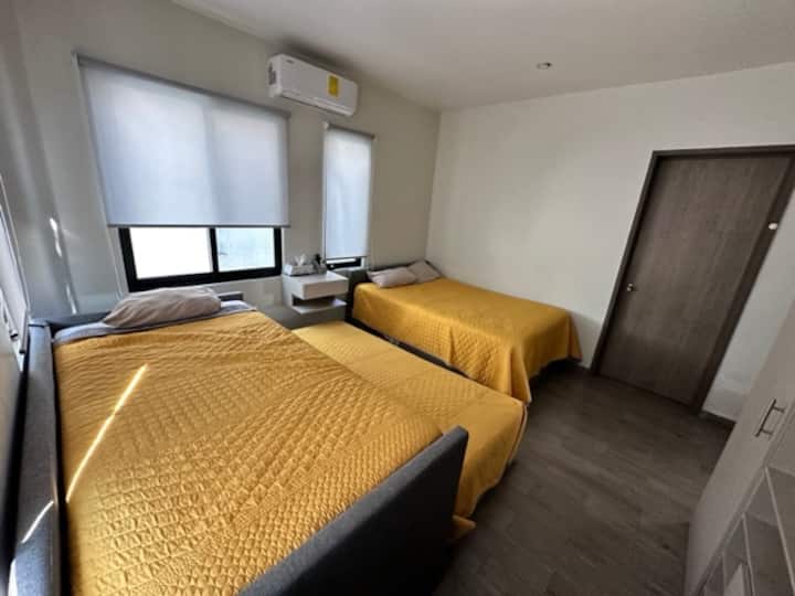 bedroom 1, two twin beds, one double bed and full bathroom