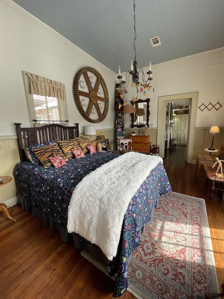 Queen-sized bed in a sunny room with river views