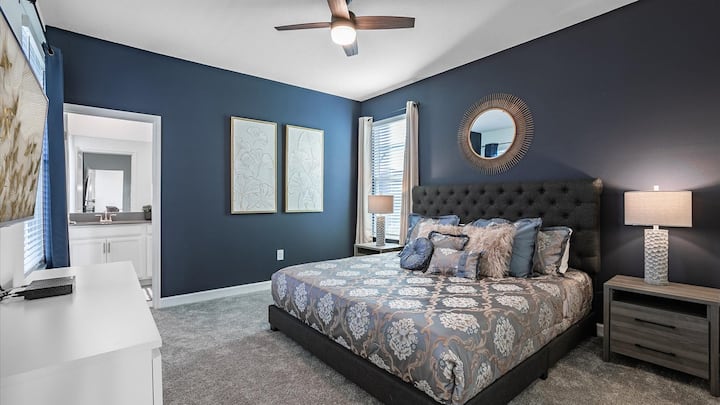 Poolside master bedroom with private ensuite bathroom equipped with 50 inch Roku TV