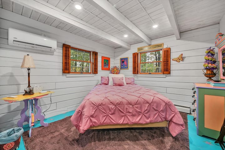 This bedroom is off of the main floor hallway next to a full bath. The queen bed's angle is adjustable to your liking by remote, and also offers massage settings. 

There’s plenty of room in the dresser and closet to store your clothes.