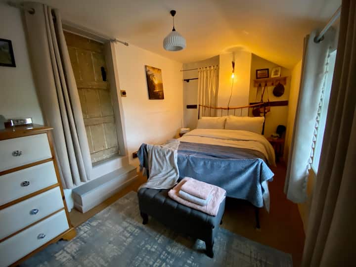 Bedroom 2. Double bed with Emma mattress. Adjoining door to bedroom 1, steps up. Door curtain.