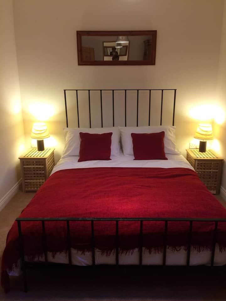 Large king-size bed in the main bedroom