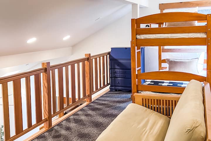 Upstairs open loft above the living room features a twin bed bunk for kids and adults alike.