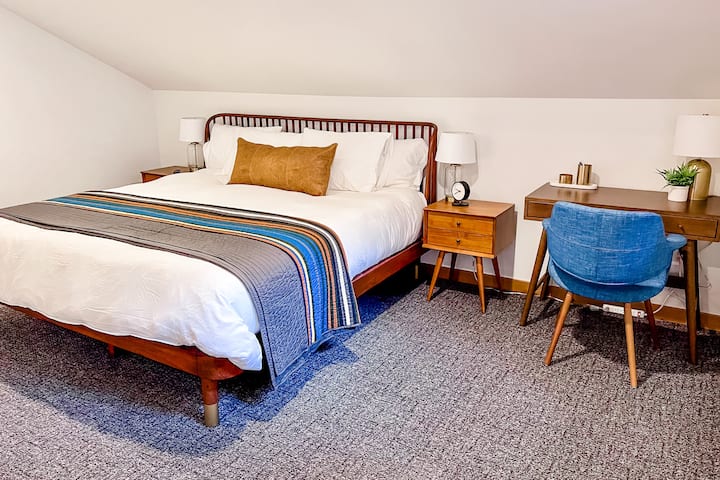 The upstairs primary bedroom features a king size bed, 43" smart TV, dedicated work space, large closet, attached bath, and "the nest".