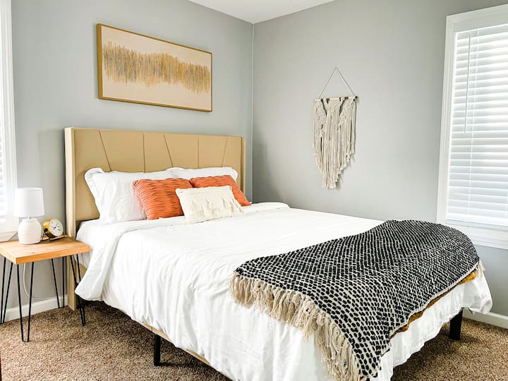 Cozy second bedroom with modern bed, dresser, and large closet with generous storage space.